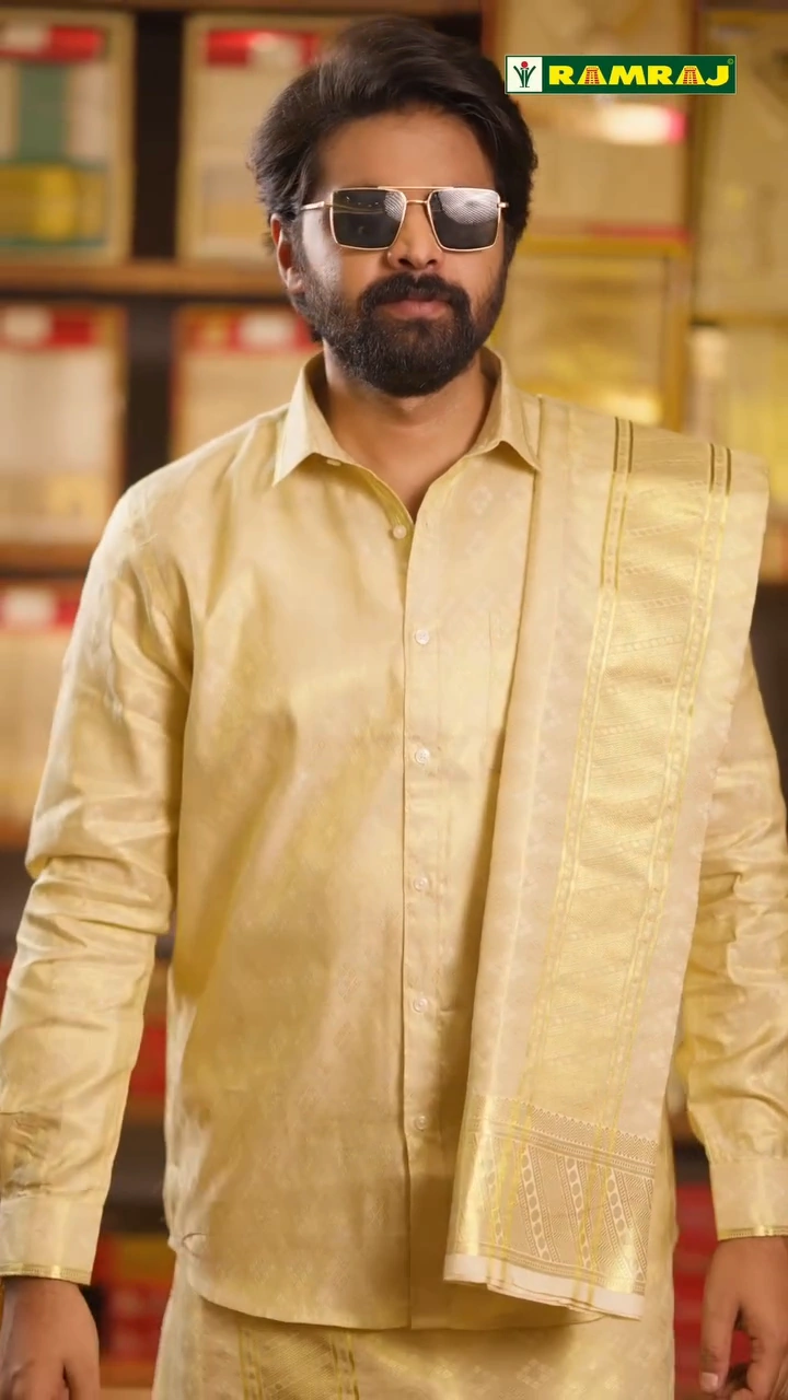 Ramraj campaign portrait in a gold shirt and sunglasses