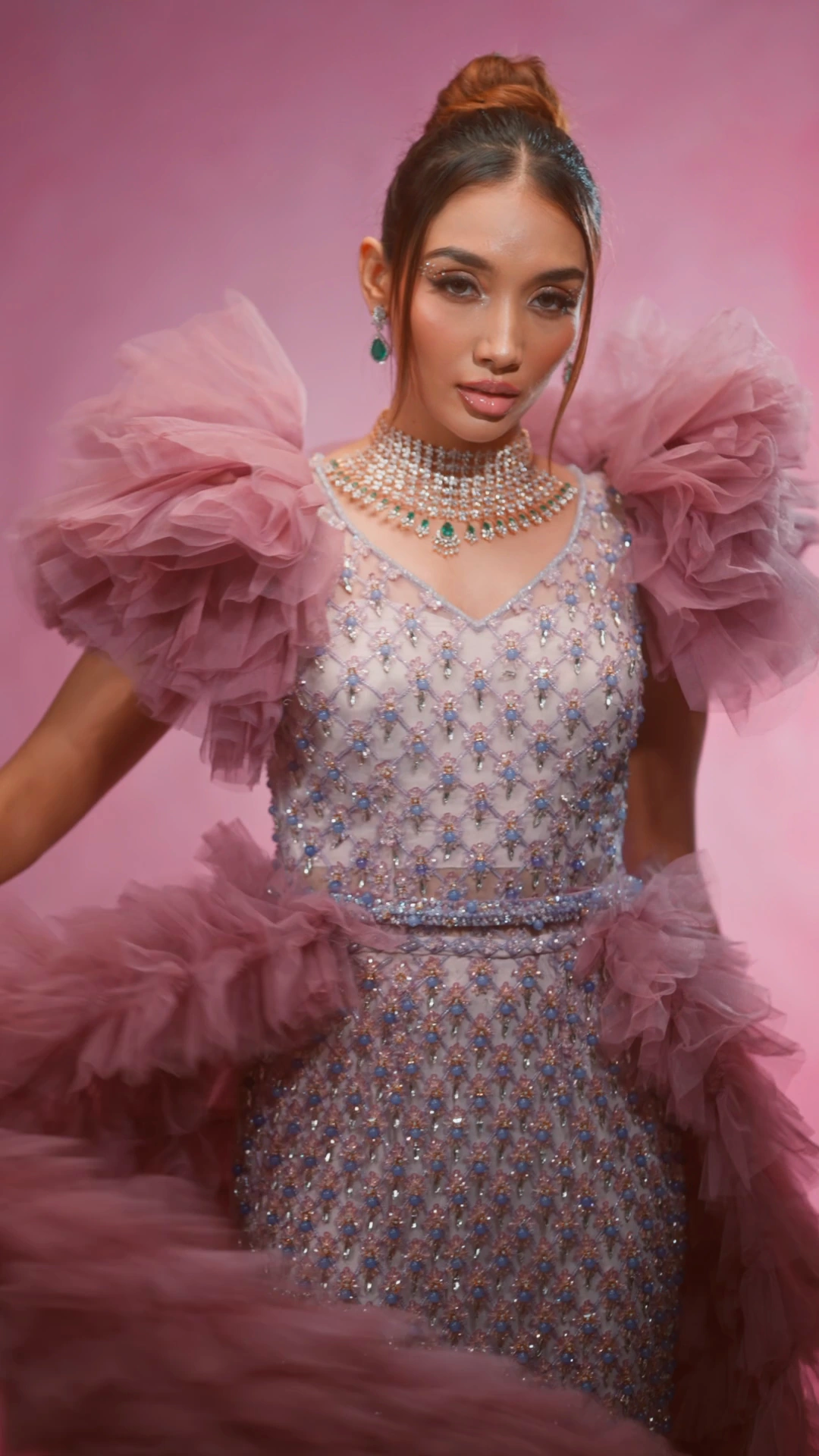 Sancheti Gems model in a lilac dress against a pink backdrop